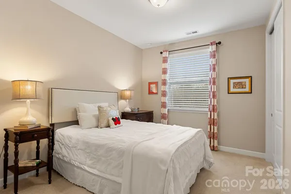 a bedroom with a bed and a night stand