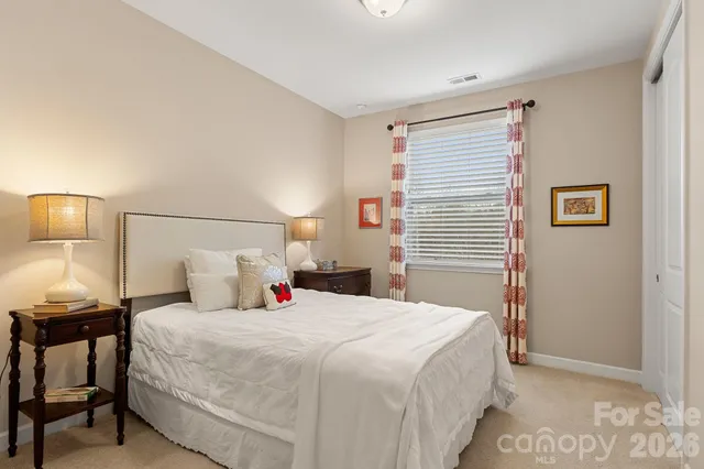 a bedroom with a bed and a night stand