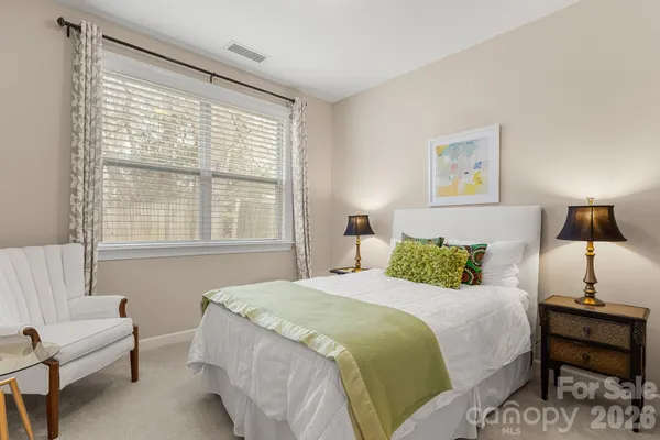 a bedroom with a bed and a couch