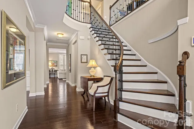 a view of entryway and hall with wooden floor