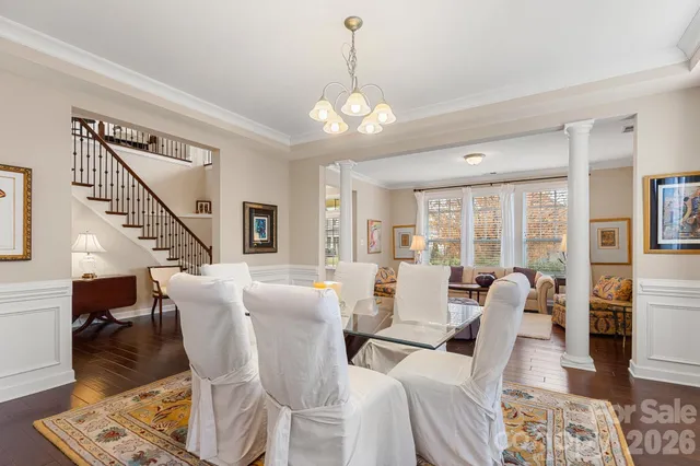 a view of a dining room with furniture wooden floor and chandelier