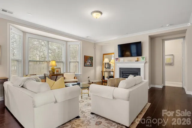 a living room with fireplace furniture and a flat screen tv