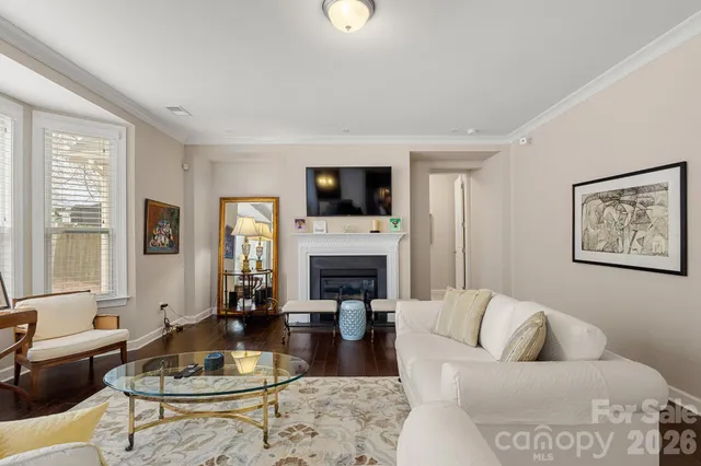 a living room with furniture a fireplace and a flat screen tv