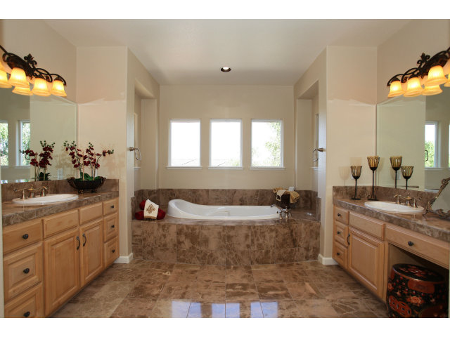 5504 Perugia Circle San Jose, CA 95138 - Photo 18 of 25 a bathroom with a tub sink double vanity and mirror