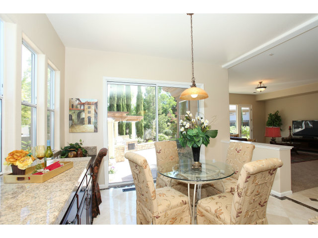 5504 Perugia Circle San Jose, CA 95138 - Photo 8 of 25 a dining room with furniture a chandelier and wooden floor
