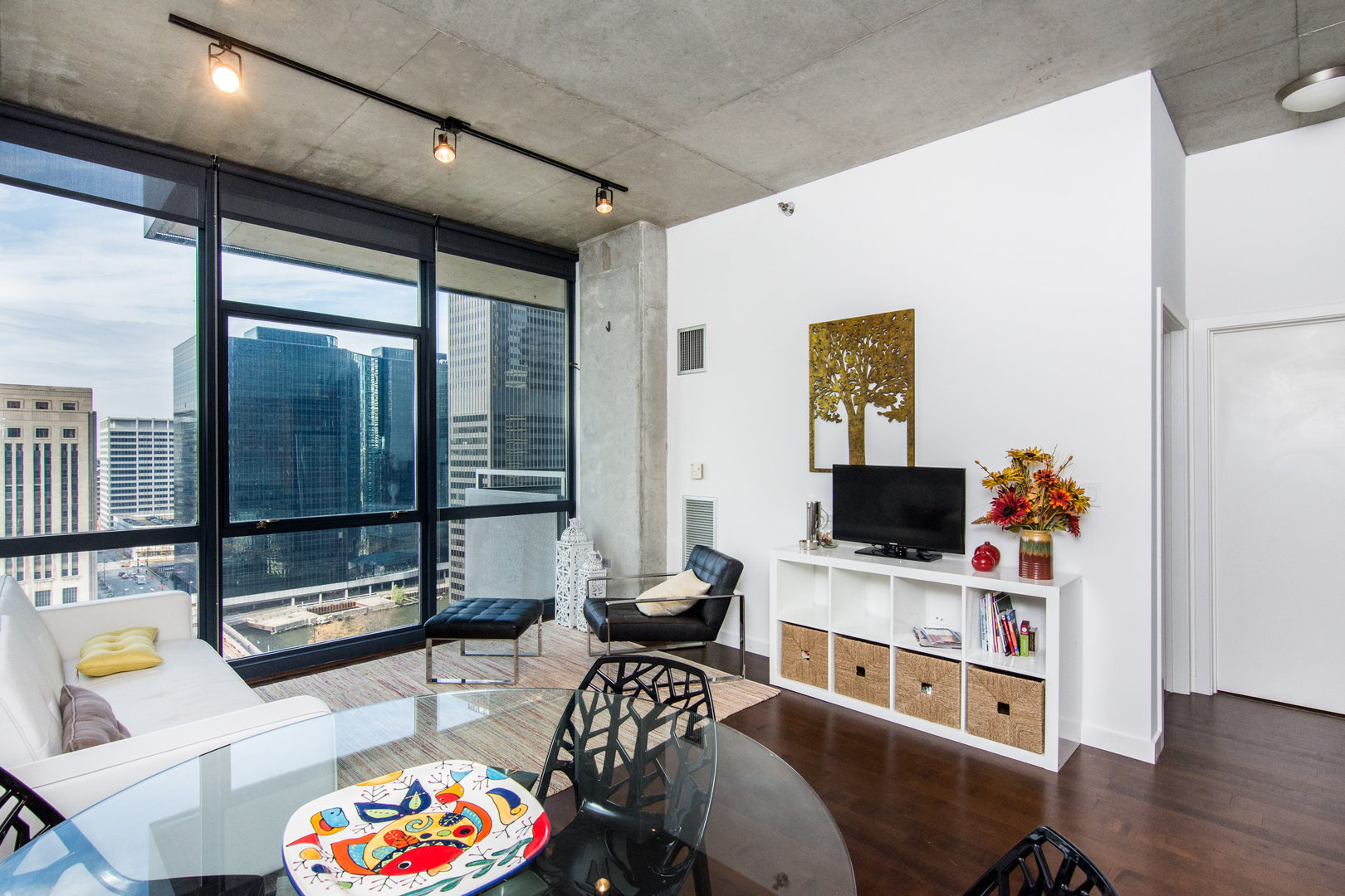 235 West Van Buren Street, Unit 1913 Chicago, IL 60607 - Photo 2 of 13 a living room with furniture and a flat screen tv