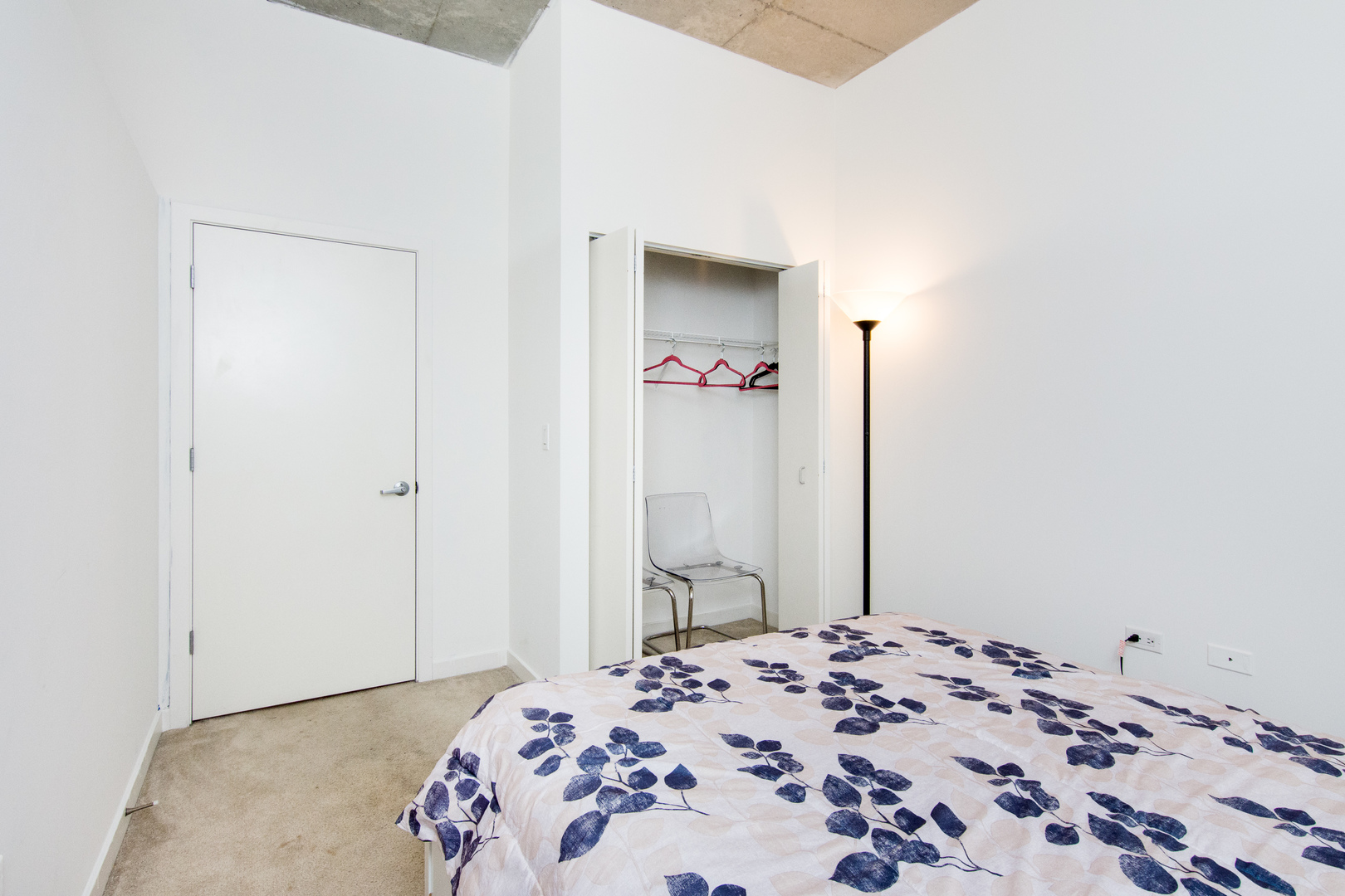 235 West Van Buren Street, Unit 1913 Chicago, IL 60607 - Photo 10 of 13 a bedroom with a bed and a mirror