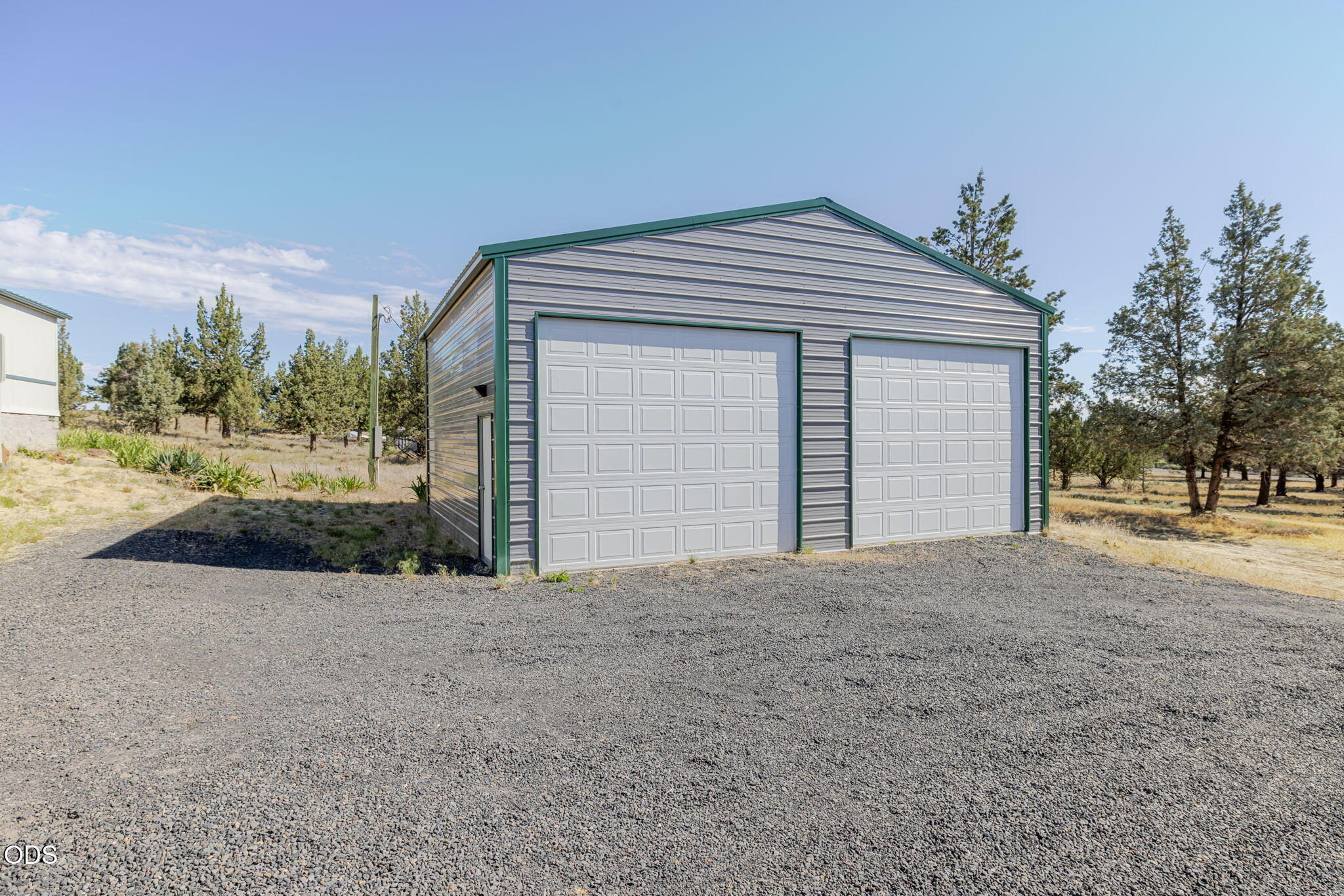 8628 Southwest Crater Loop Road Terrebonne, OR 97760 - Photo 25 of 36 a view of a house with a yard and garage