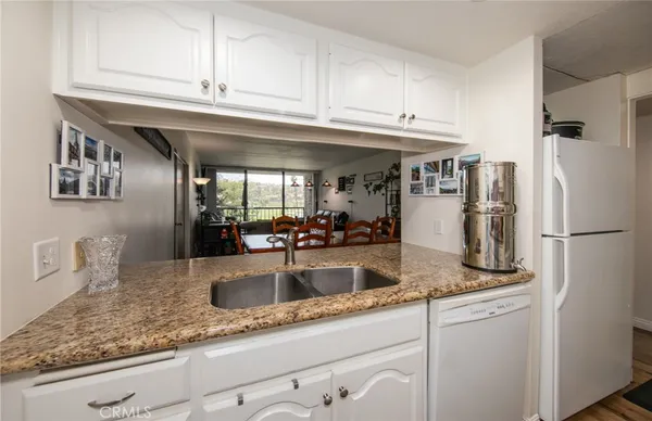 a kitchen with stainless steel appliances granite countertop a sink and cabinets