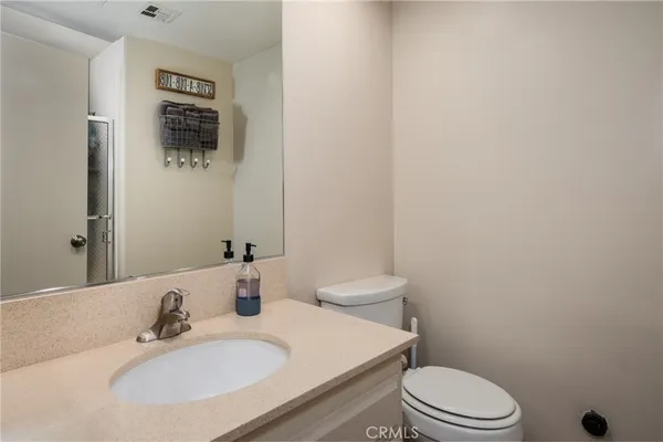 a bathroom with a sink toilet and mirror