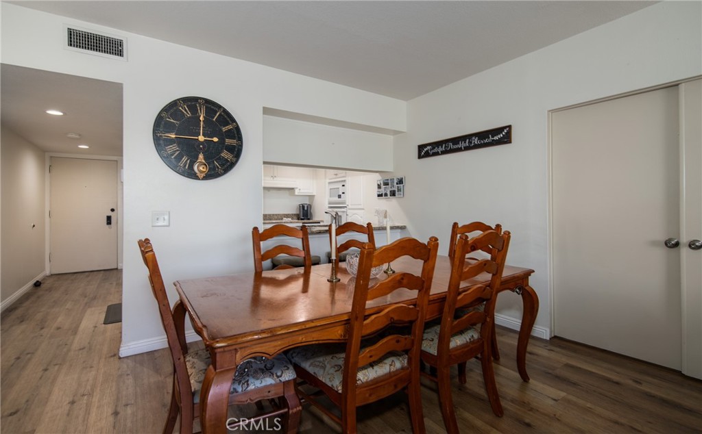 5555 Canyon Crest Drive, Unit 2G Riverside, CA 92507 - Photo 8 of 24 a view of a dining room with furniture and wooden floor