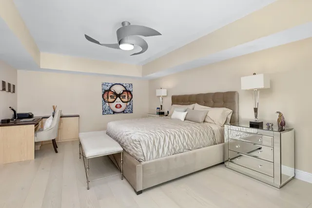 a bedroom with a bed and a lamp