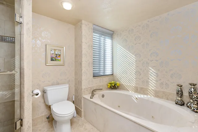 a white bath tub sitting next to a white toilet