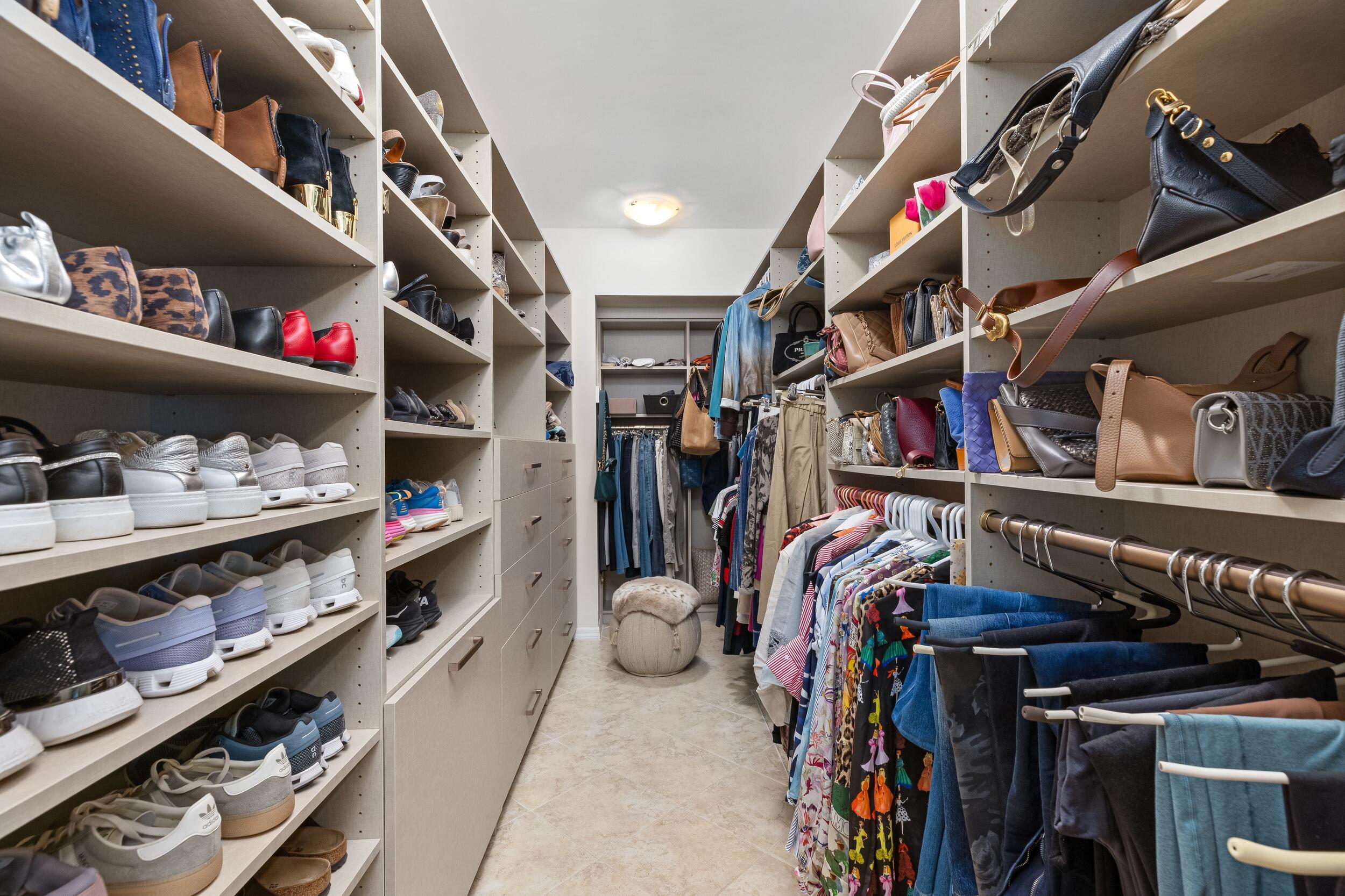 100 Southeast 5th Avenue, Unit 207 Boca Raton, FL 33432 - Photo 24 of 46 a view of walk in closet with clothes and shoes