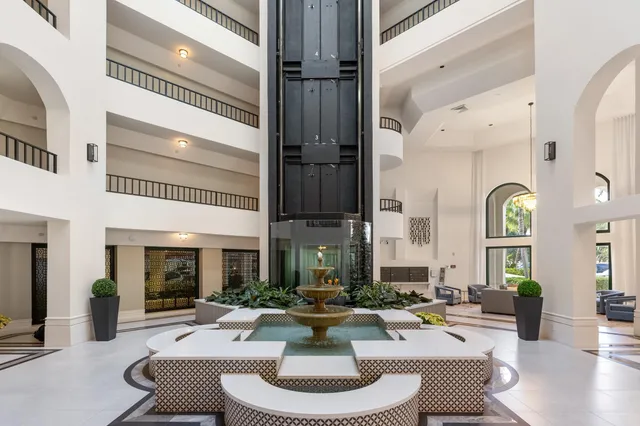 a living room with fireplace furniture and a large window