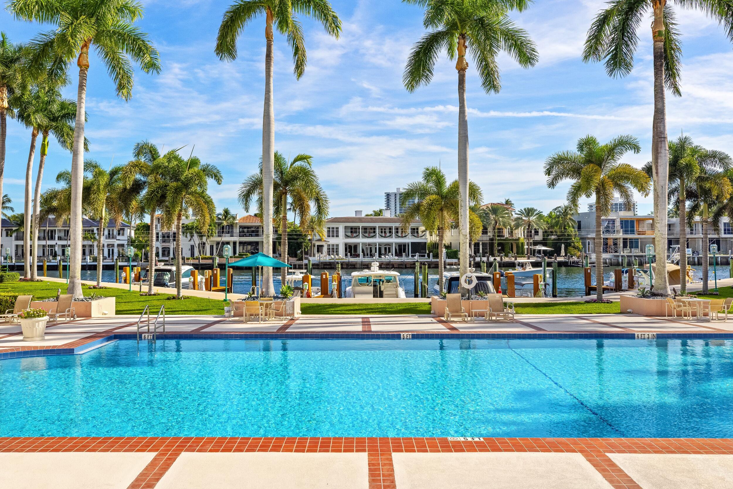 100 Southeast 5th Avenue, Unit 207 Boca Raton, FL 33432 - Photo 40 of 46 a view of swimming pool with lawn chairs under palm trees