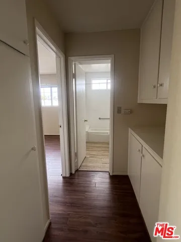 a view of hallway with wooden floor
