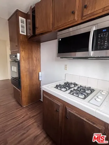 a kitchen with stainless steel appliances granite countertop a stove and a microwave