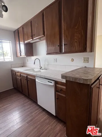 a kitchen with stainless steel appliances granite countertop a sink stove and wooden cabinets