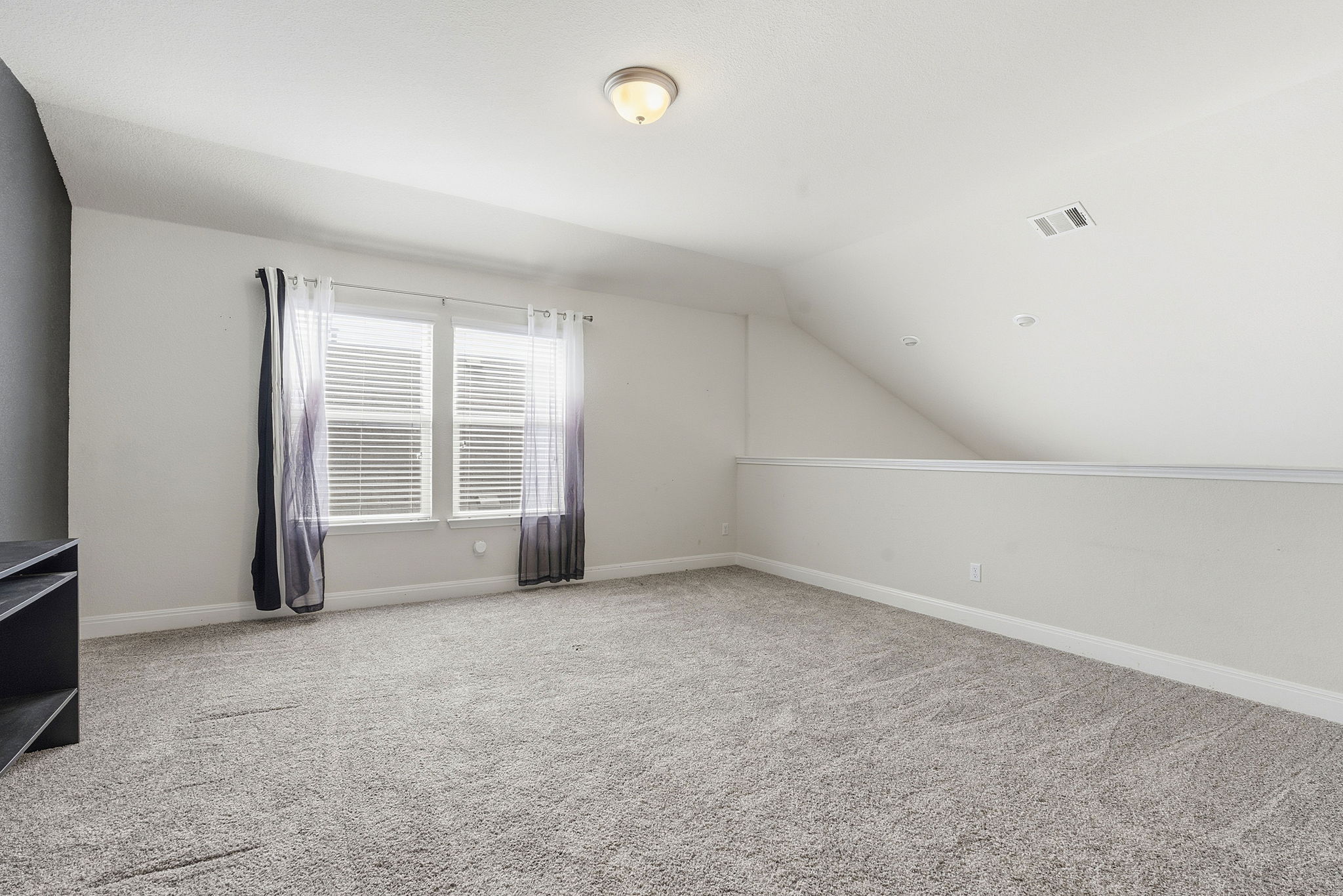 117 Methodius Drive Hutto, TX 78634 - Photo 19 of 40 Additional living space with vaulted ceiling and light carpet on 2nd floor