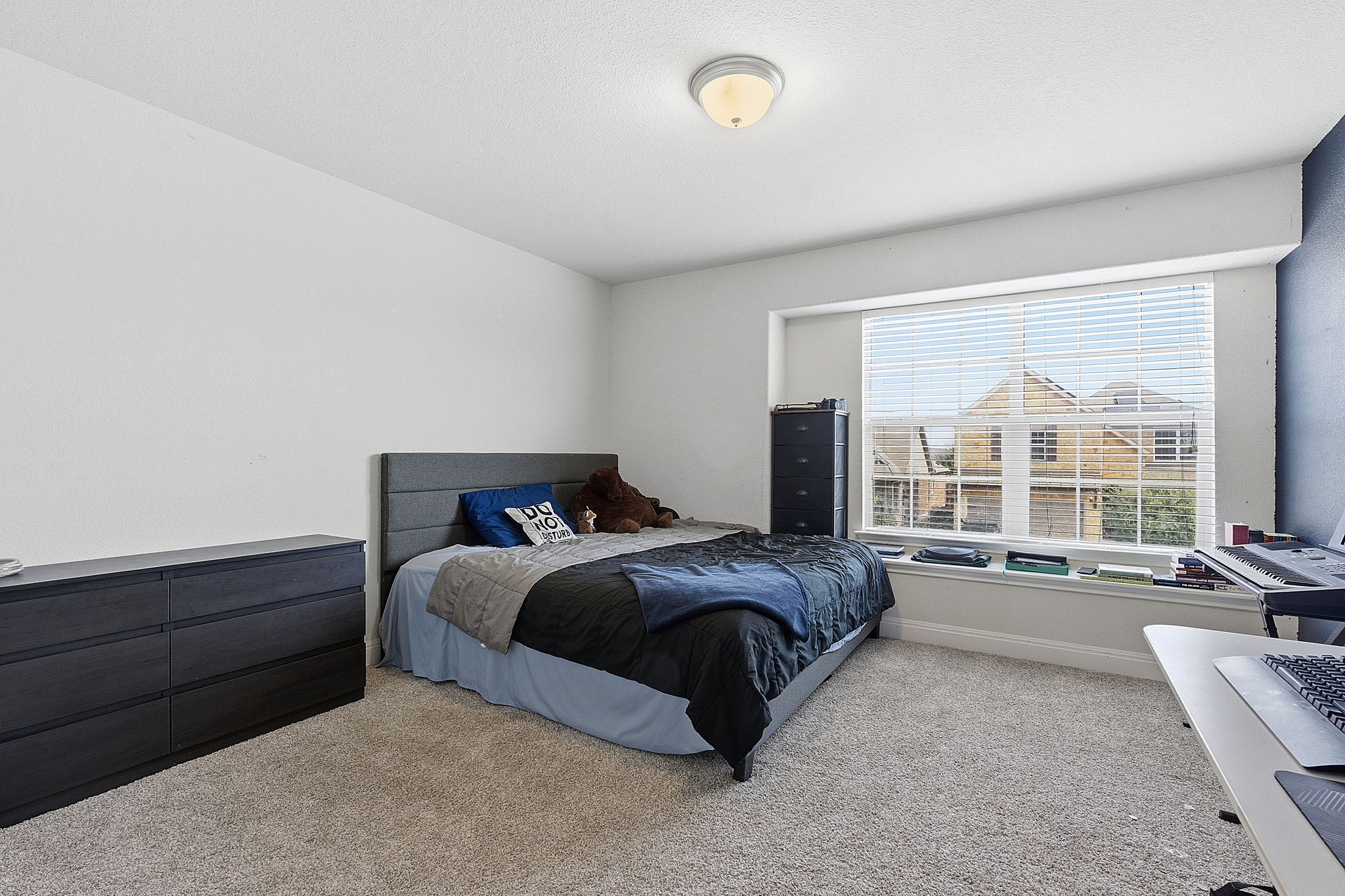 117 Methodius Drive Hutto, TX 78634 - Photo 22 of 40 Bedroom featuring carpet and baseboards