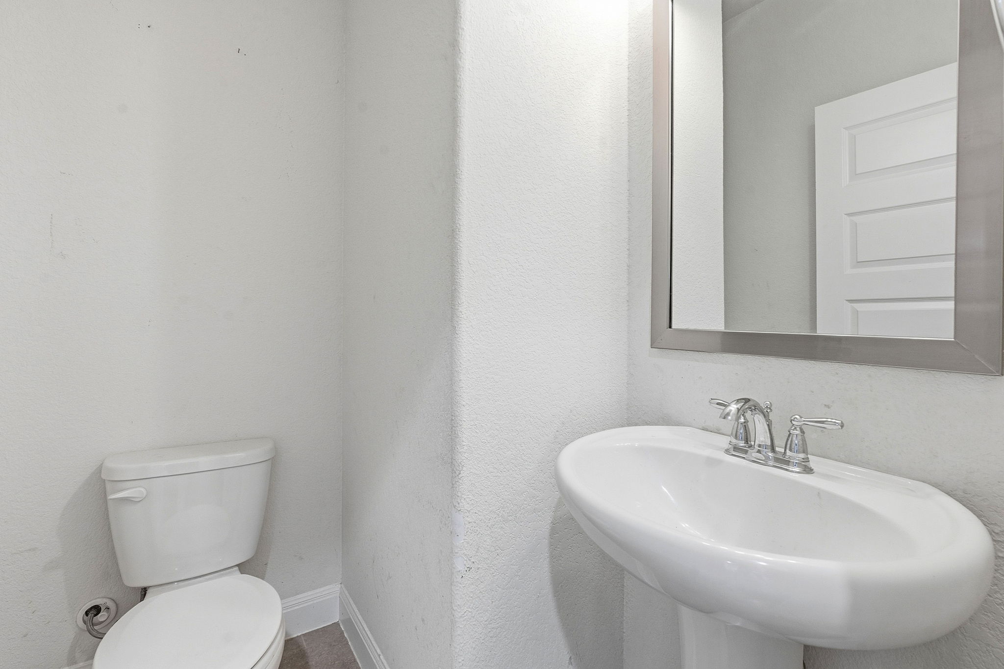 117 Methodius Drive Hutto, TX 78634 - Photo 27 of 40 Half bath with toilet and a textured wall