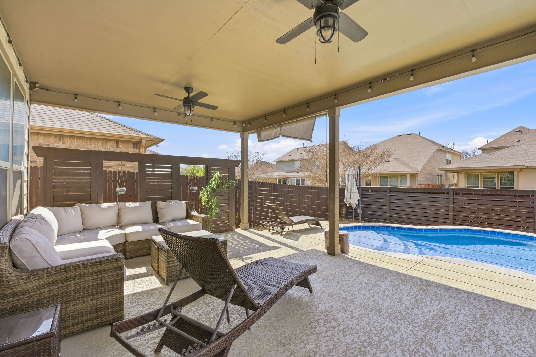 117 Methodius Drive Hutto, TX 78634 - Photo 30 of 40 Fenced backyard with ceiling fan, a patio area, and outdoor furniture