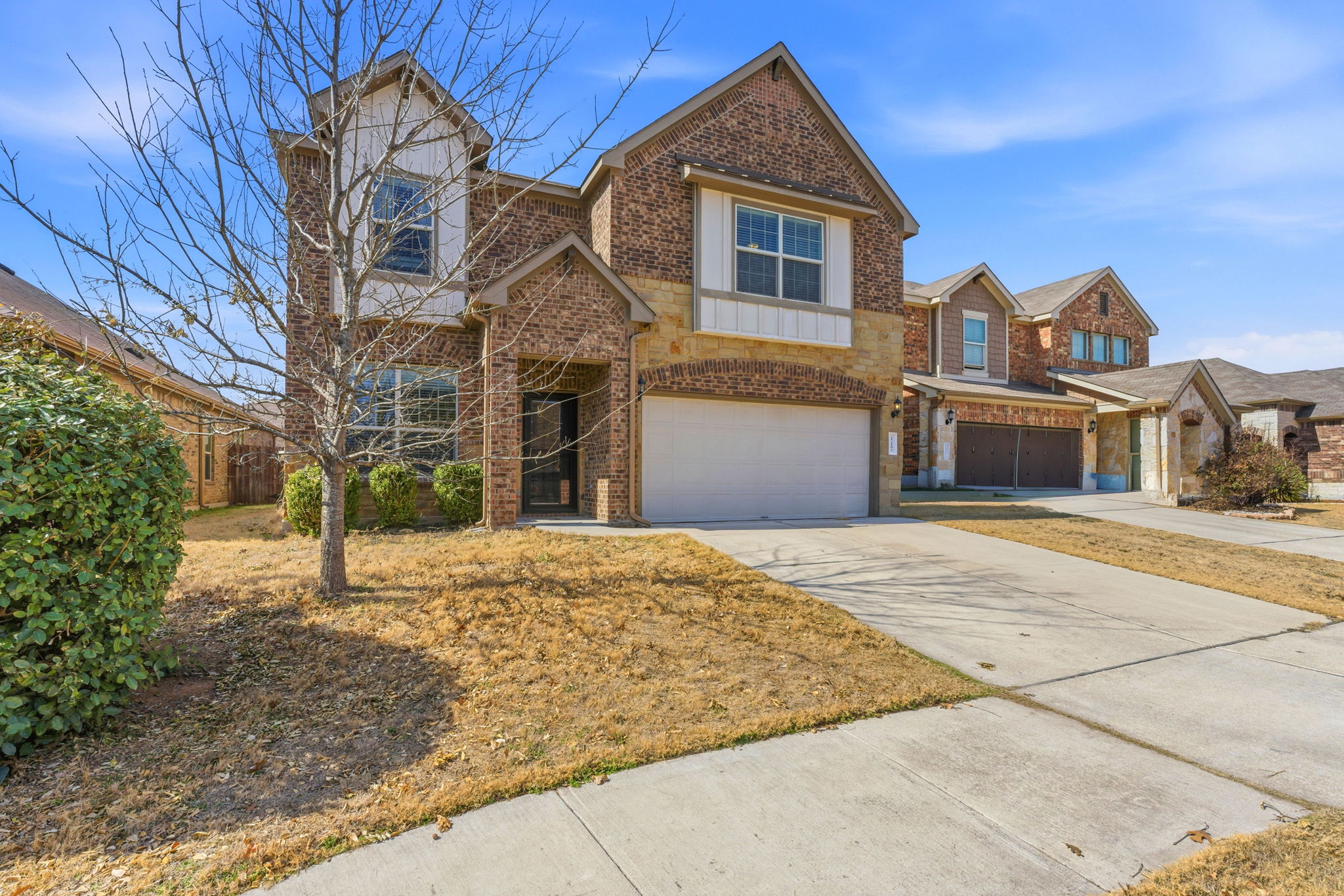 117 Methodius Drive Hutto, TX 78634 - Photo 3 of 40 View of front of property with brick siding, an attached garage, and concrete driveway