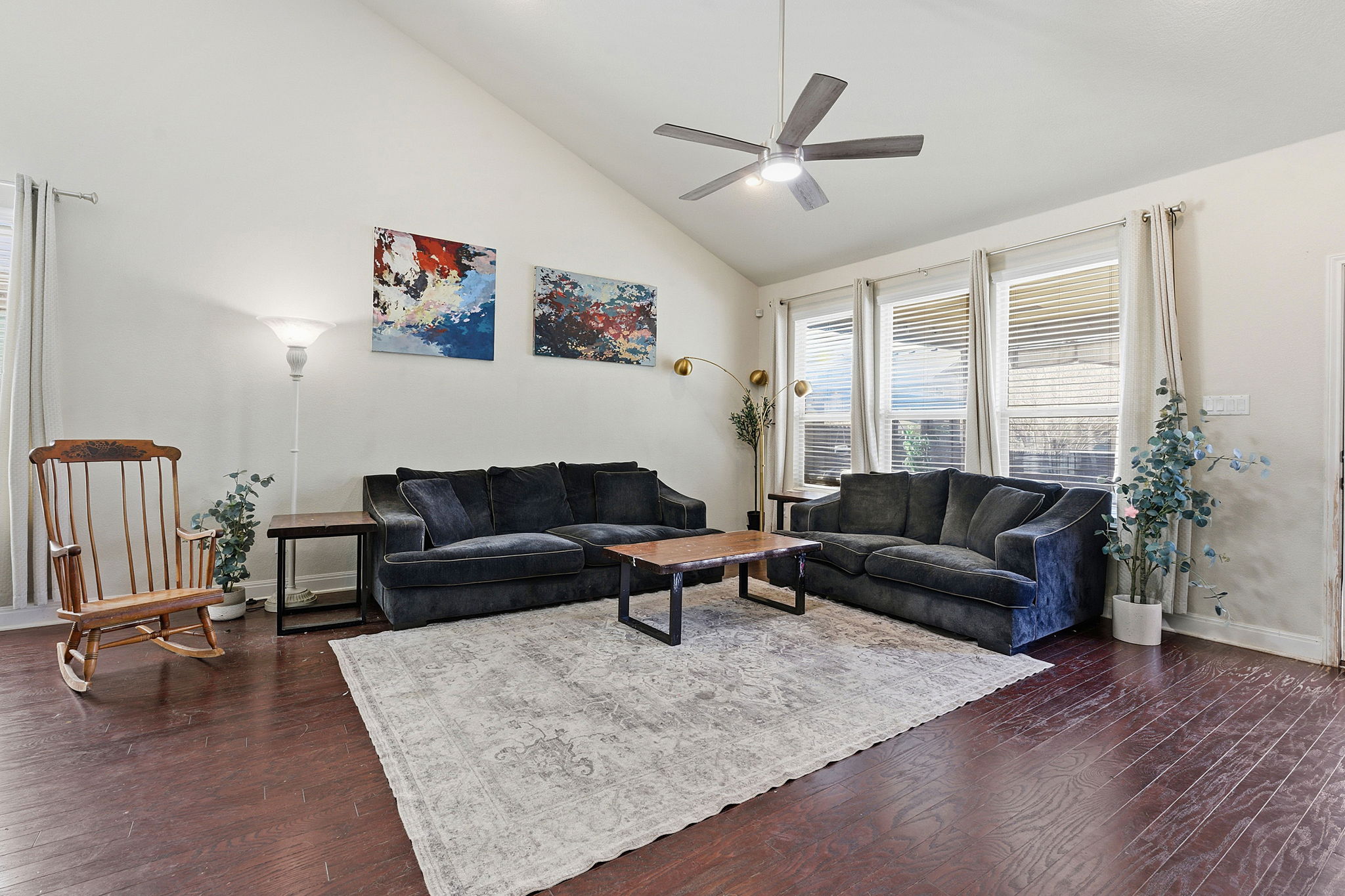 117 Methodius Drive Hutto, TX 78634 - Photo 4 of 40 Living room featuring vaulted ceiling, dark wood finished floors, and a ceiling fan