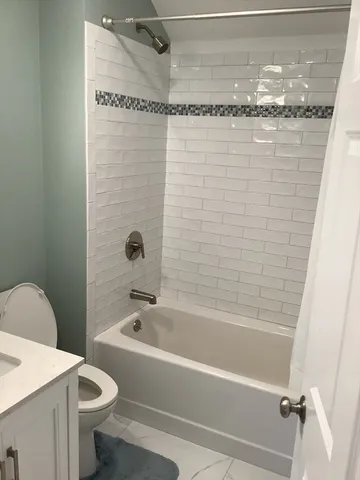 a bathroom with a shower and a toilet
