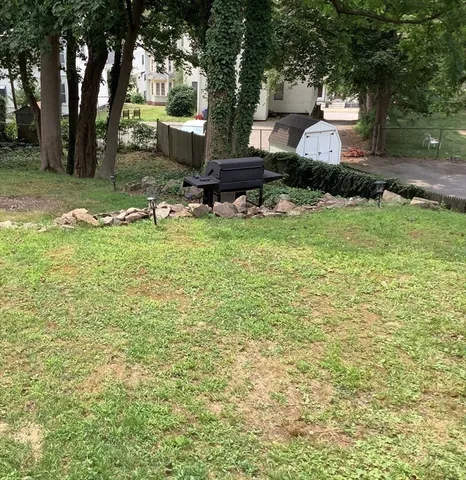 a view of a backyard with large trees