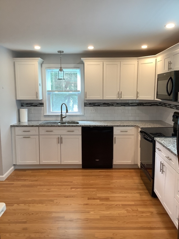 10 Moulton Court, Unit 10 Beverly, MA 01915 - Photo 6 of 21 a kitchen with stainless steel appliances granite countertop a sink stove and cabinets