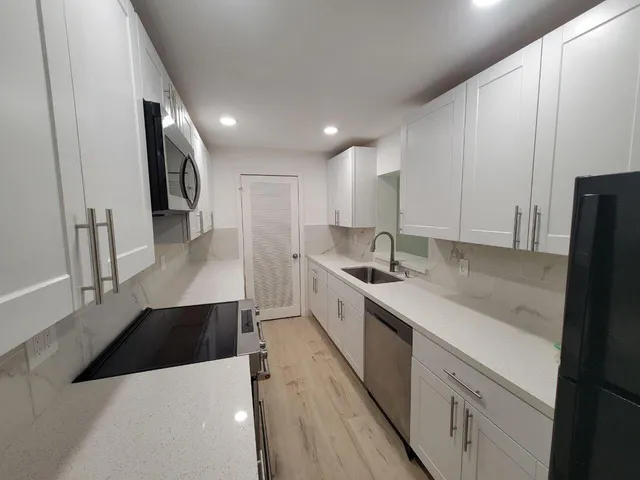 a kitchen with a sink and a refrigerator