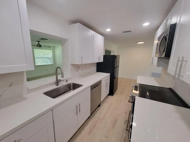 a kitchen with a sink and a stove top oven