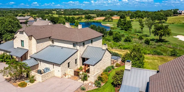 an aerial view of a house with a yard