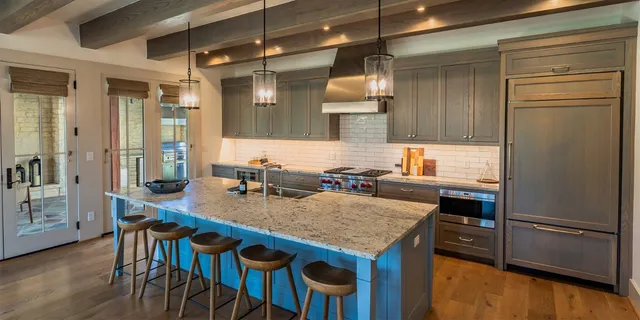 a kitchen with a table chairs refrigerator and cabinets