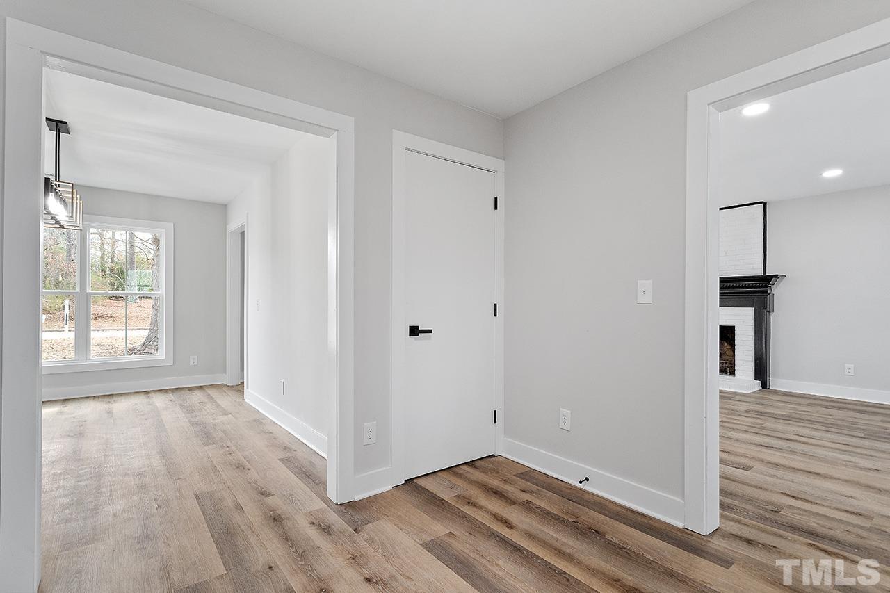 8205 Rocky Court Raleigh, NC 27616 - Photo 14 of 28 a view of hallway with window and wooden floor