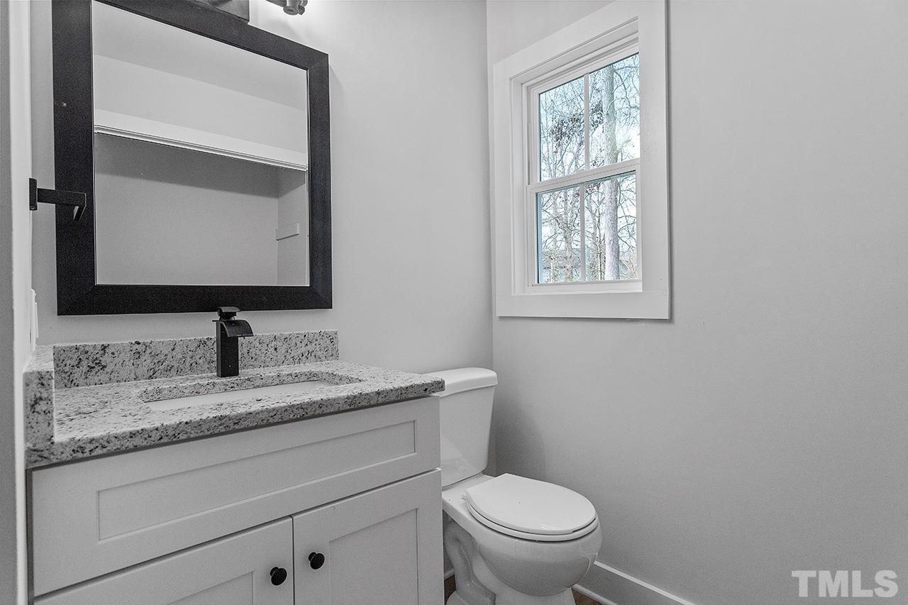 8205 Rocky Court Raleigh, NC 27616 - Photo 17 of 28 a bathroom with a granite countertop toilet sink and mirror