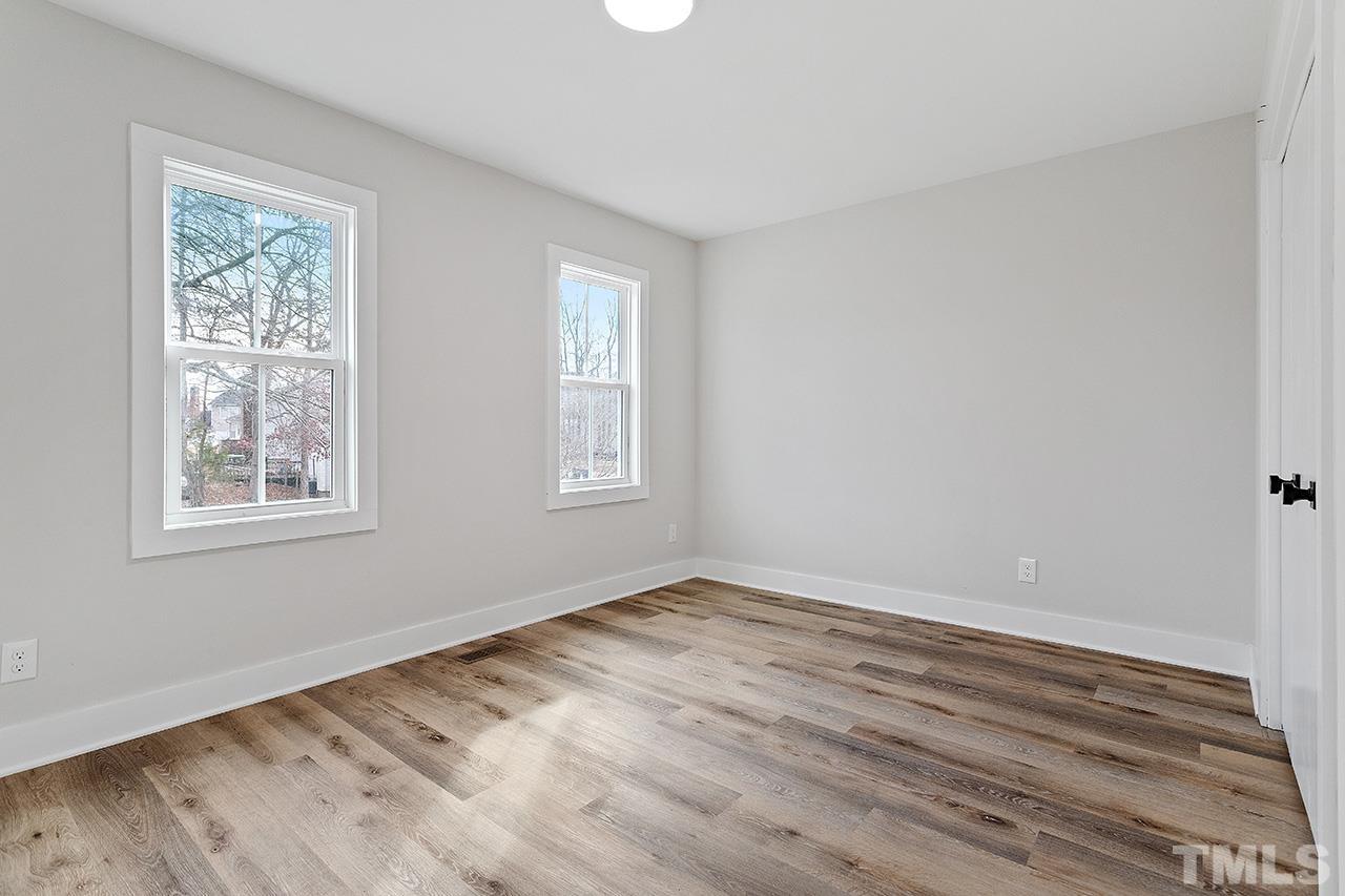 8205 Rocky Court Raleigh, NC 27616 - Photo 19 of 28 a view of empty room with wooden floor and fan