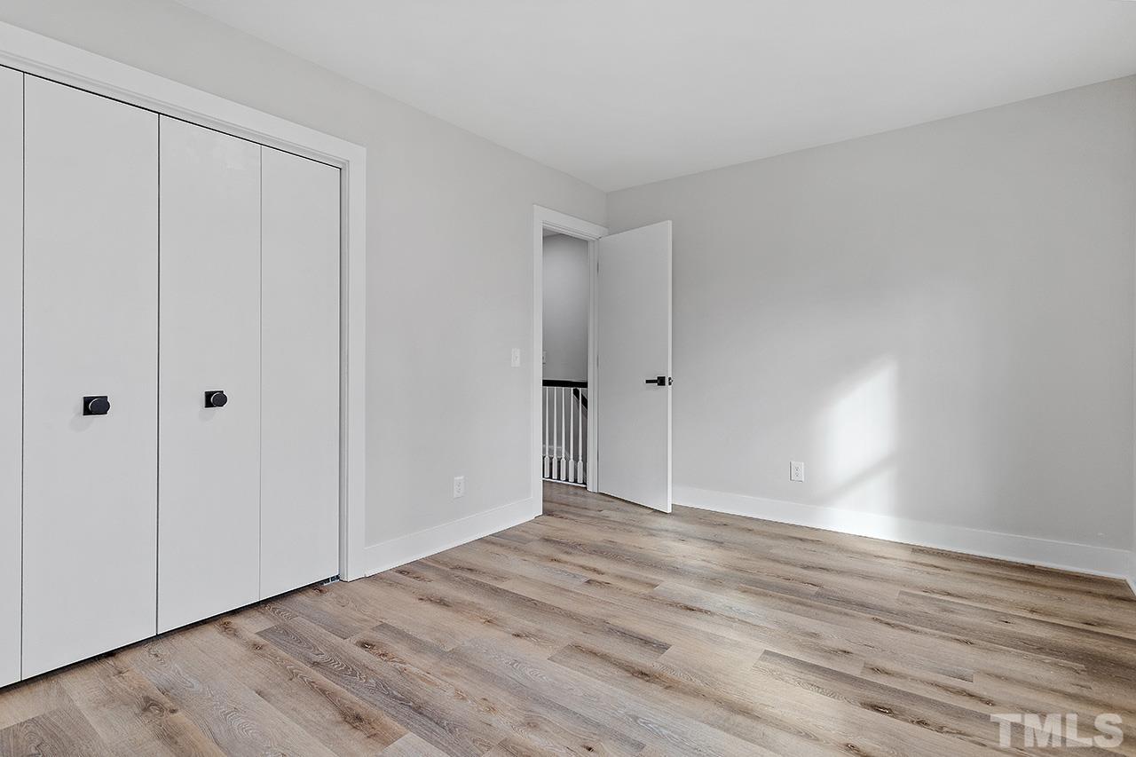 8205 Rocky Court Raleigh, NC 27616 - Photo 20 of 28 a view of an empty room with wooden floor