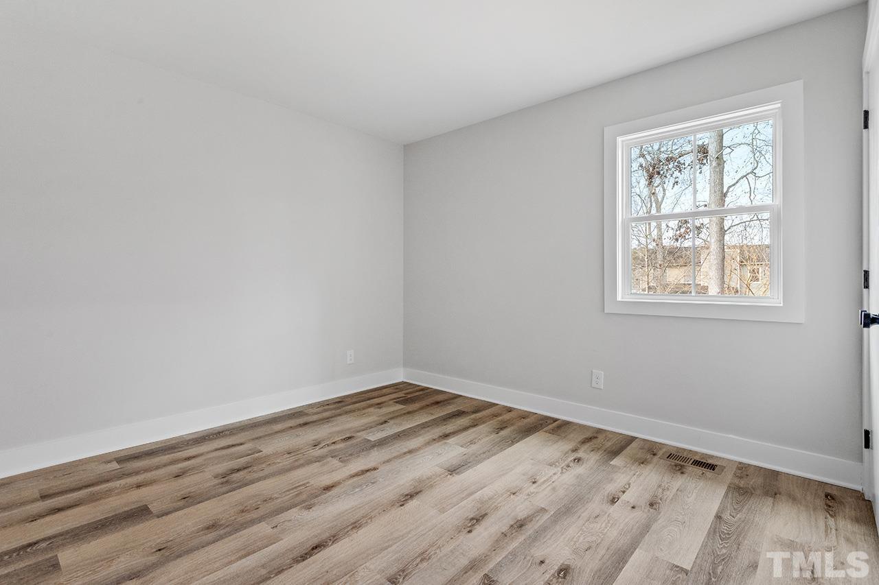 8205 Rocky Court Raleigh, NC 27616 - Photo 21 of 28 a view of a room that has wooden floor and window in it
