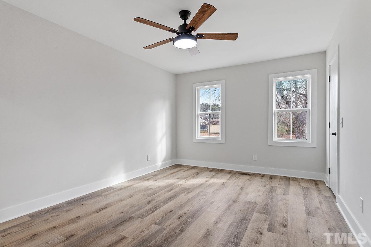 8205 Rocky Court Raleigh, NC 27616 - Photo 24 of 28 an empty room with wooden floor and windows