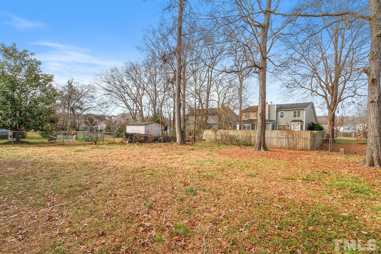 8205 Rocky Court Raleigh, NC 27616 - Photo 4 of 28 a tall house with trees in front of it