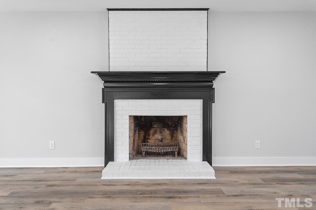 8205 Rocky Court Raleigh, NC 27616 - Photo 7 of 28 a living room with a fireplace and a fireplace