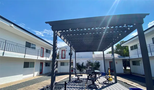 a view of a porch with furniture and floor to ceiling window