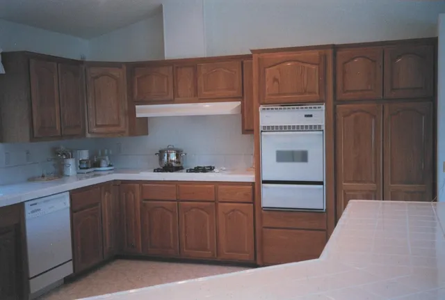 a kitchen with a sink a stove and cabinets