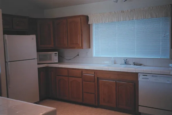 a kitchen with a sink and refrigerator