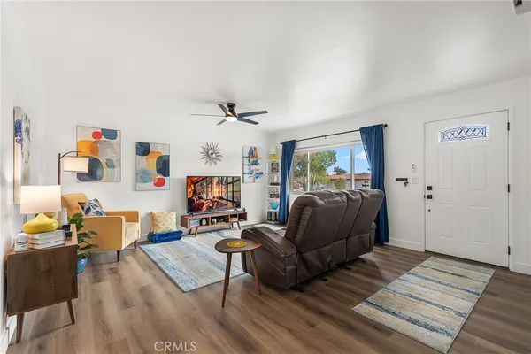 a living room with furniture and wooden floor