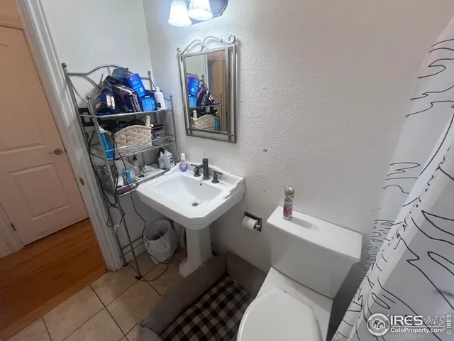 a bathroom with a sink mirror and toilet