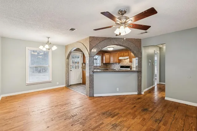 a view of a livingroom with a window and wooden floor